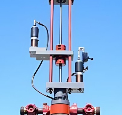 Gate valve drilling unit rigged up on a wellhead against a clear sky